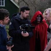 Callum Brown (centre) with cast and crew working on The Red Veil