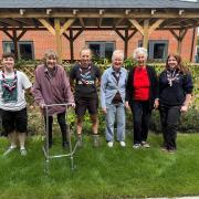 Scouts and residents plant flowers and friendships in garden revamp