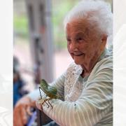 A resident gets hands-on with an exotic insect during a surprise visit