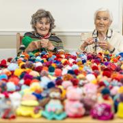 Woodpeckers residents Dawn Pearson and Phyllis Farmer with hats knitted at the Colten Care home in aid of the Big Knit