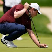 Robert MacIntyre, of Scotland, places his ball on the eight hole during the third round of the U.S. Open golf tournament at Oakmont Country Club Saturday, June 14, 2025, in Oakmont, Pa. (AP Photo/Carolyn Kaster)