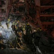 Israeli security forces inspect destroyed buildings that were hit by a missile fired from Iran (AP/Ohad Zwigenberg)