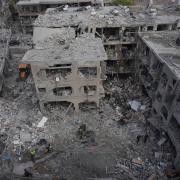 Israeli first responders work in a residential area near Tel Aviv, Israel, hit by a missile fired from Iran (Ariel Schalit/AP)
