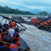 Rescuers work at the site of a bridge collapse near Pune, India (AP Photo)