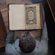 Dr Tony Trowles, head of the Abbey Collection, with a rare first edition of the Welsh Bible (Yui Mok/PA)
