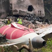Officials inspect the site of Thursday’s Air India plane crash (Ajit Solanki/AP)