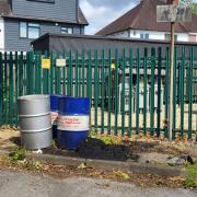 Oil drums left abandoned in Maybush
