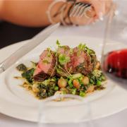 Roast rump of lamb with a glass of red wine