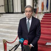Tanaiste Simon Harris speaking to the media at Government Buildings (Grainne Ni Aodha/{PA)