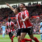 Shane Long and Dusan Tadic celebrate against Manchester City