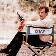 FILE - British actor Roger Moore, playing the title role of secret service agent 007, James Bond, is shown on location in England in 1972. Moore, played Bond in seven films, more than any other actor.  Roger Moore's family said Tuesday May 23, 2017 th