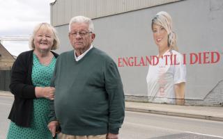 Left to right: Anne and Graham Hunter at the mural of their daughter Claire