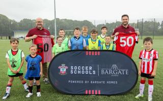 Representatives from Bargate Homes with children at a Saints Soccer School at Deer Park School, near Botley