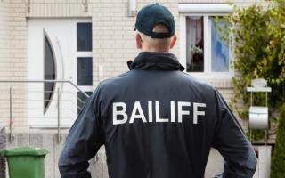 A bailiff enforcing a repossession.