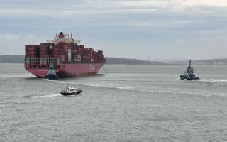 Container ship One Maneuver being assisted by three tug boats and the harbour master.