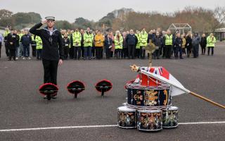 Trainee Engineering Technician Marine Engineering William Lamont lays a wreath.