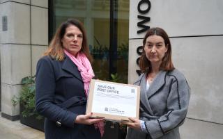 Caroline Nokes MP handing over the petition signatures from residents