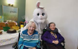 Court Lodge residents Irene Fraser and Sybil Skinner meet the Easter Bunny. 