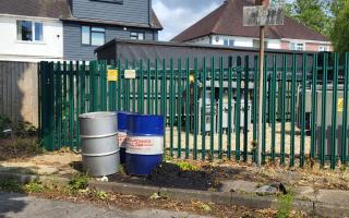 Oil drums left abandoned in Maybush