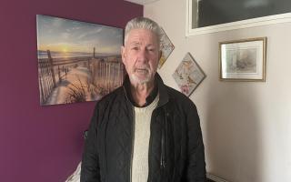 Terry Bampton, 71, inside his lounge, where he has to sleep due to rats scurrying in the loft above his bedroom.