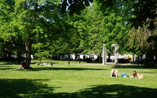 People enjoying the warm weather in Palmerston Park