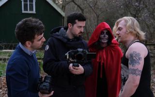 Callum Brown (centre) with cast and crew working on The Red Veil