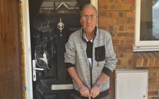 Lorrimer Christians, standing outside his front door on Condor Close, which was smashed in when police raided his house in March.