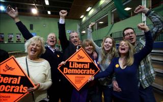 Liberal Democrat Mike Thornton celebrates with his family.