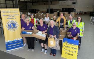 Boxes of hygiene items and food stacked for Ukraine-bound transport